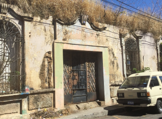 A house with weeds growing